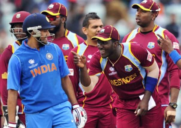 India's Rohit Sharma waits for a third umpire decision while West Indies' Darren Sammy makes his point. Picture: Getty