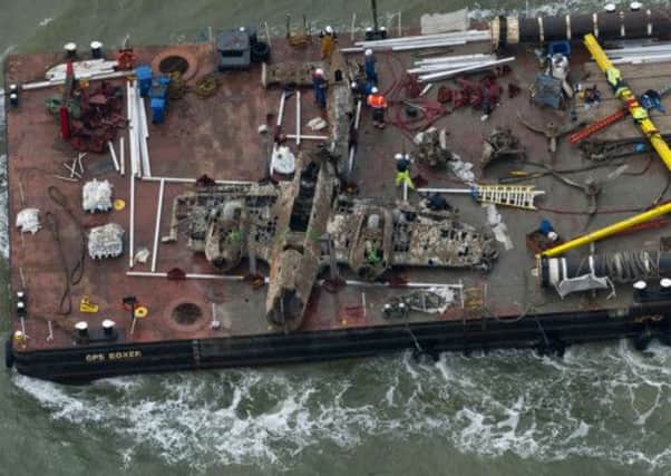 The wreck of the German World War II Dornier Do-17 plane is transported on a barge. Picture: Getty