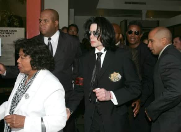 Michael Jackson leaves court with his mother Katherine after being acquitted of child abuse charges on this day in 2005. Picture: AP