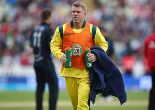 Suspended David Warner was on watercarrying duty for Australia yesterday. Picture: Michael Steele/Getty