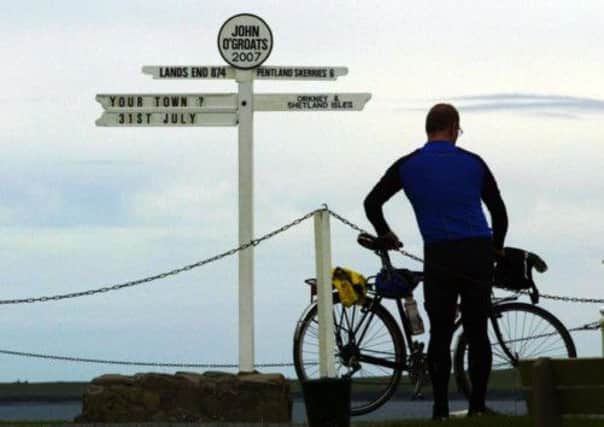 A cyclist surveys the scene at John o' Groats. Picture: PA