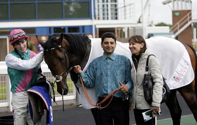 Jockey James Doyle and trainer Lady Cecil with winner Morpheus at Nottingham. Picture: PA