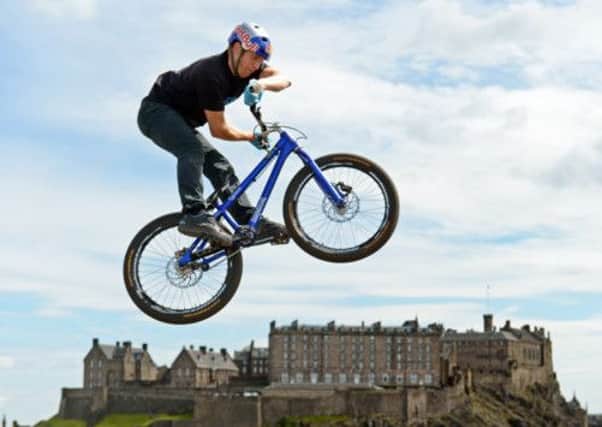 Danny MacAskill leaps over Edinburgh Castle as he promotes Bike Week. Picture: Phil Wilkinson