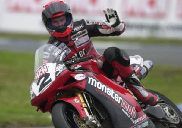 Steve Hislop on his Monster Mob Ducati celebrates victory at the Knockhill round of the British Superbike championship in 2002. Picture: Tony Marsh
