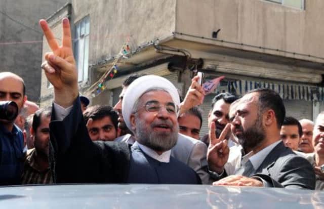 Hasan Rowhani greets supporters with a victory sign in Tehran after casting his vote in Friday's election. Picture:AP