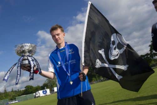 Lovat's Stuart MacDonald starts the celebrations after the MacTavish Cup final win over Glen Urquhart. Picture: SNS