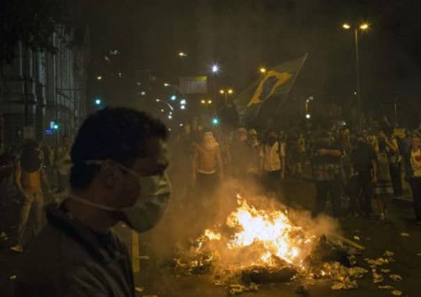 Protesters burn rubbish to block a street in Rio de Janeiro. Picture: AP