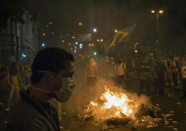 Protesters burn rubbish to block a street in Rio de Janeiro. Picture: AP