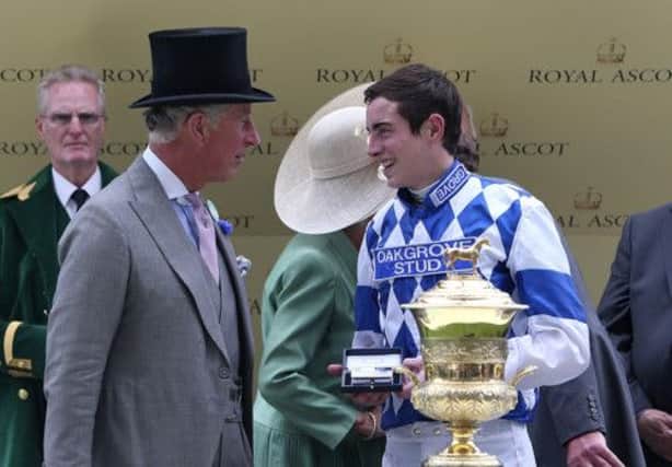 The Prince of Wales presents the trophy to James Doyle after winning the Prince of Waless Stakes on Al Kazeem. Picture: PA