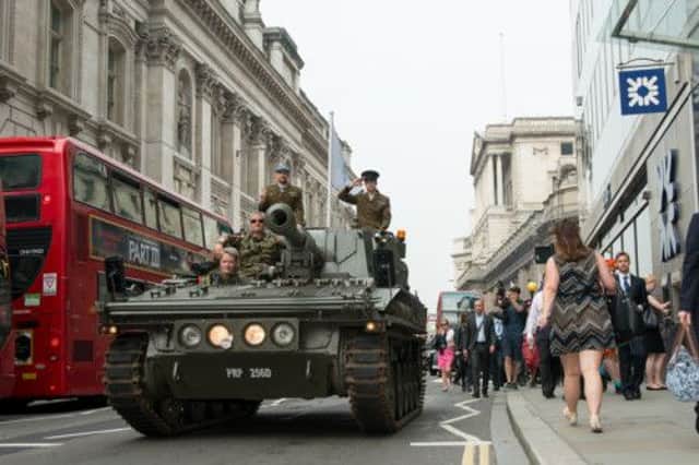 BrewDog cofounders James Watt and Martin Dickie arrive in the City of London in typically unorthodox fashion, driving past the Bank of England in a tank . Picture: Contributed