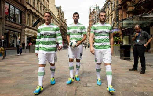 Celtic trio Kris Commons, Joe Ledley and Adam Matthews take to the streets of Glasgow to launch the new home kit. Picture: SNS