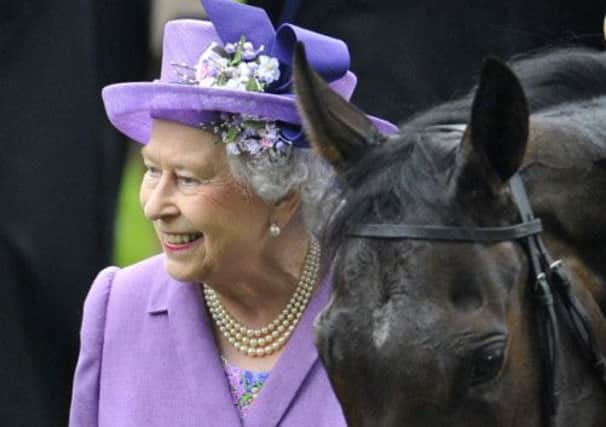 The Queen with day three winner Estimate. Picture: Reuters