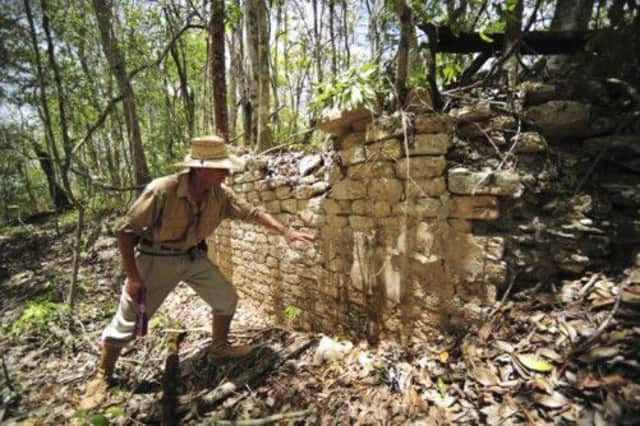An archaeologist shows the remains of a building at the newly discovered ancient Maya city Chactun in Yucatan. Picture: Reuters