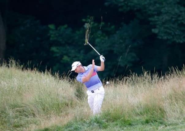 Sergio Garcia hacks out of the extremely long grass at Merion. Picture: Getty