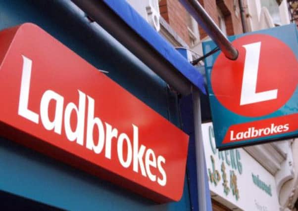 Police are hunting a man who robbed a branch of Ladbrokes in West Lothian. Picture: PA