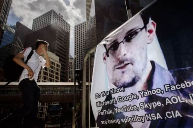 A man walks past a banner showing support for the fugitive Edward Snowden. Picture: Getty