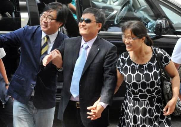 Chen Guangcheng, centre and his wife arrive at a press conference in Taipei. Picture: Getty