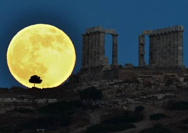 A supermoon rises next to the ancient Greek temple of Poseidon at Cape Sounion. Picture: Getty