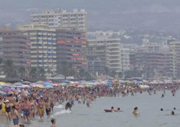 Holidaymakers in Fuengirola, where three people believed to from Britain have been found shot dead. Picture: PA