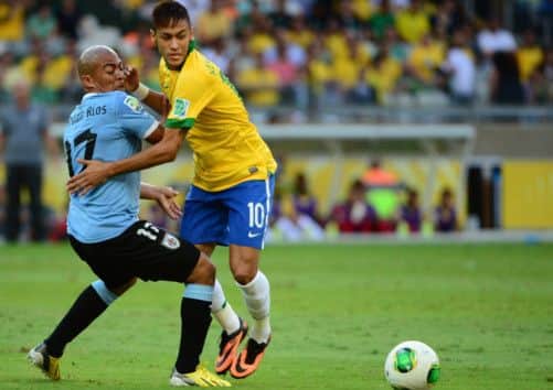 Neymar takes on Uruguay's Egidio Arevalo Rios. Picture: Getty