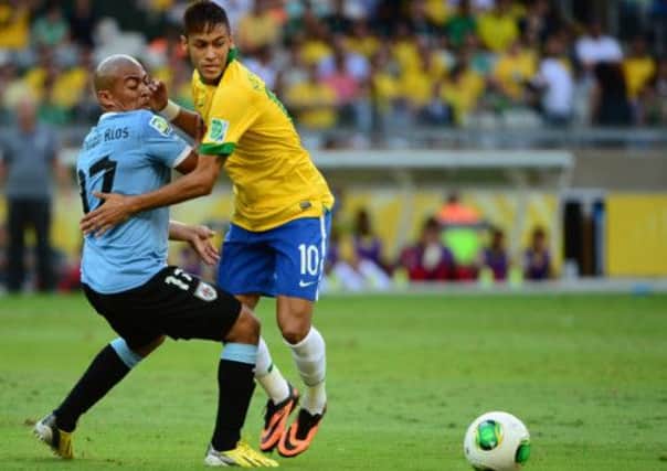 Neymar takes on Uruguay's Egidio Arevalo Rios. Picture: Getty