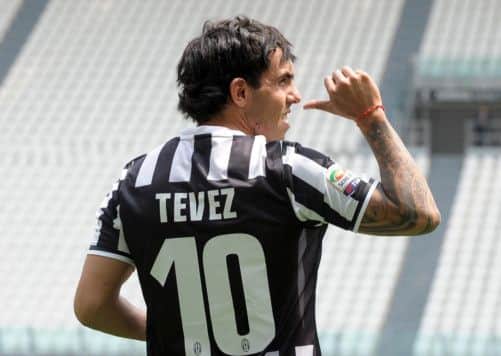 Carlos Tevez poses in his new Juventus jersey. Picture: AP