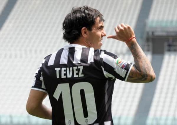 Carlos Tevez poses in his new Juventus jersey. Picture: AP