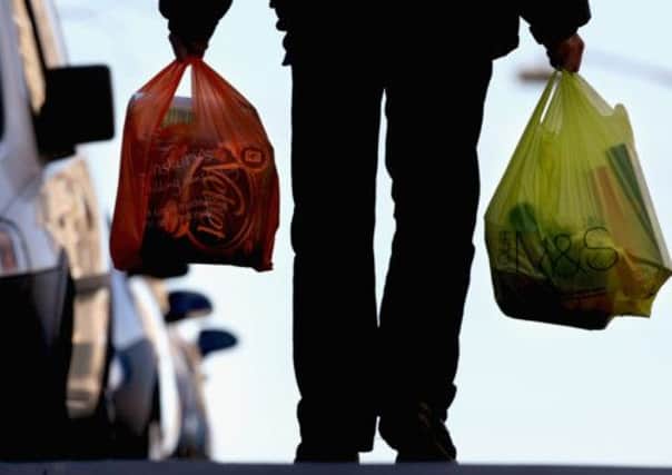 A man takes his shopping home in plastic carrier bags. Picture: Getty