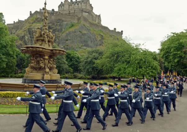 Armed forces members march past Edinburgh Castle. Picture: Phil Wilkinson