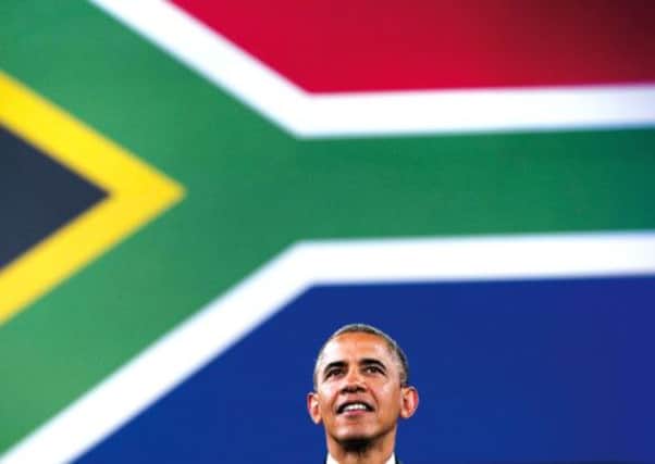 Barack Obama in front of a South African flag at the University of Johannesburg, Soweto. Picture: AFP/ Getty