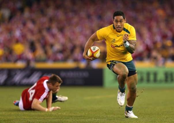 Australia's Christian Leal'ifano runs clear of Tommy Bowe. Picture: Getty