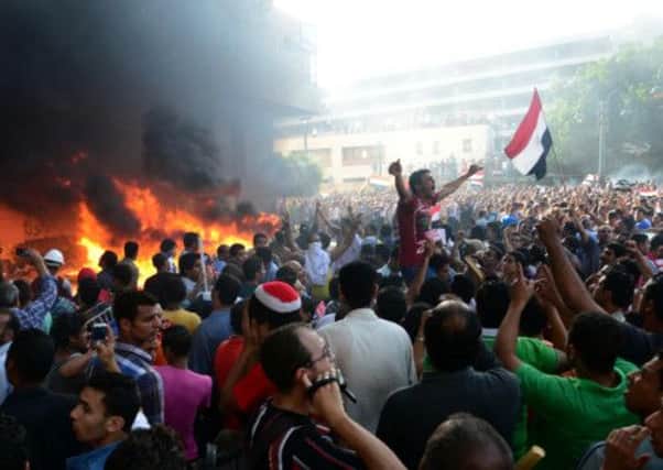 Opponents of Egypt's Islamist President Mohammed Morsi outside the Muslim Brotherhood headquarters in Alexandria. Picture: AP
