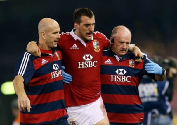 Lions captain Sam Warburton helped off the field. Picture: PA