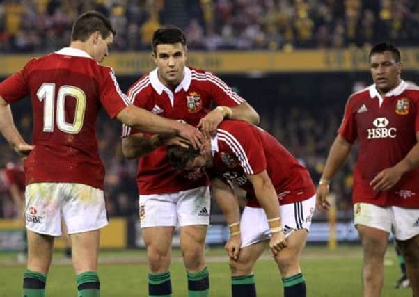 Jonny Sexton, left, and Conor Murray console full-back Leigh Halfpenny. Picture: PA
