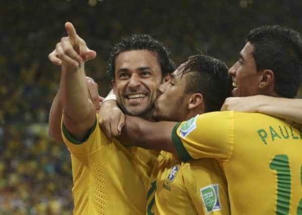Brazils two-goal hero Fred, left, is congratulated by fellow goalscorer Neymar, centre and Paulinho. Picture: AP