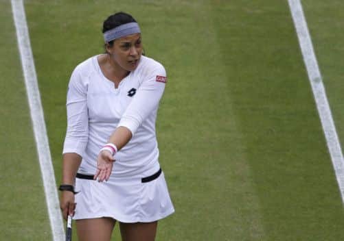Marion Bartoli of France speaks with the umpire during her quarterfinal win. Picture: AP