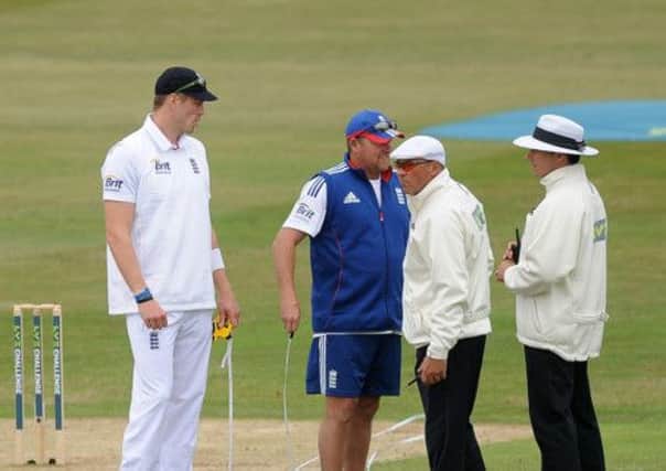 Bowler William Boyd Rankin and bowling coach David Saker of England chat with the umpires. Picture: Getty