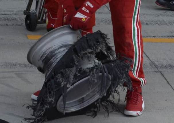 One of Felipe Massa's tyres, held by a Ferrari mechanic. Picture: Reuters