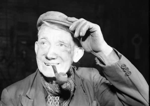 A Glasgow shipyard worker with his bunnet and pipe in 1959. Picture: TSPL