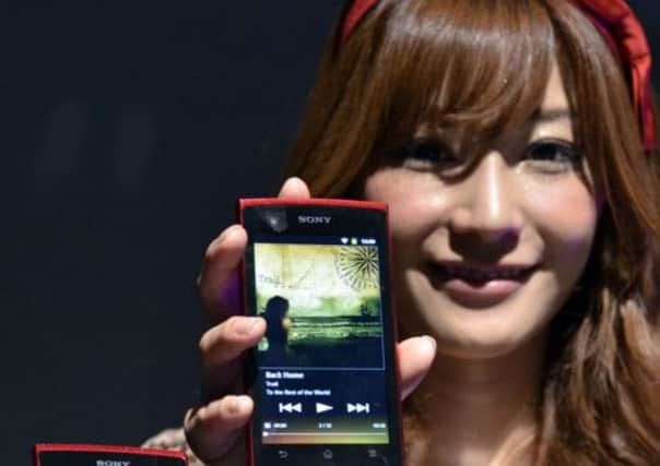 A model displays Android devices by Sony. Picture: AFP