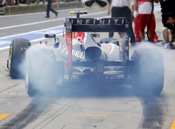 Mark Webber makes a smoke-filled departure from the pit lane during the second free practice at Nuerburgring yesterday. Picture: AP