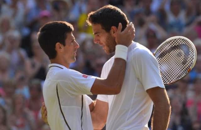 Novak Djokovic, left, and Juan Martin Del Potro embrace at the net after their enthralling contest. Picture: Getty