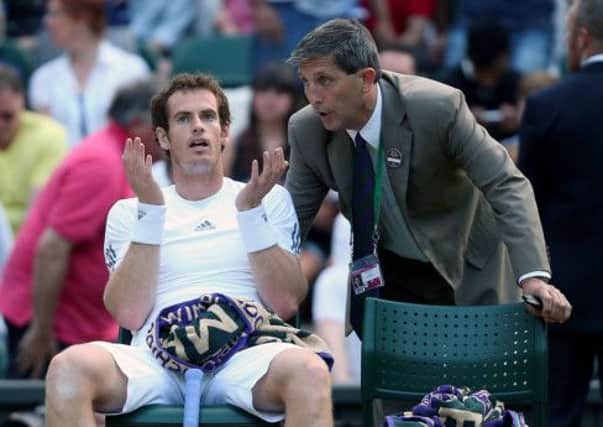 Andy Murray argues with referee Andrew Jarrett over his decision to close the roof. Picture: PA