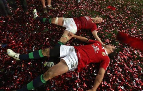 Alun-Wyn Jones and Jamie Roberts 'bathe' in confetti as they celebrate victory in the deciding Test. Picture: Getty