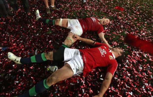 Alun-Wyn Jones and Jamie Roberts 'bathe' in confetti as they celebrate victory in the deciding Test. Picture: Getty