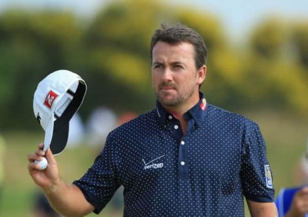 Cap that: Graeme McDowell salutes the crowd at the end of the third round in Paris. Picture: Getty
