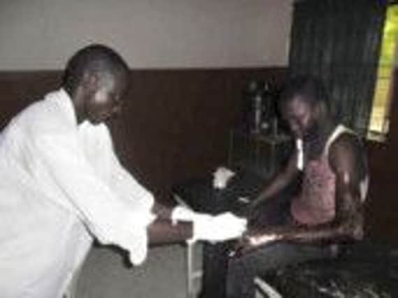 A pupil is treated for injuries in Potiskum hospital after escaping from the burning dormitory. Picture: AP/Adamu Adamu