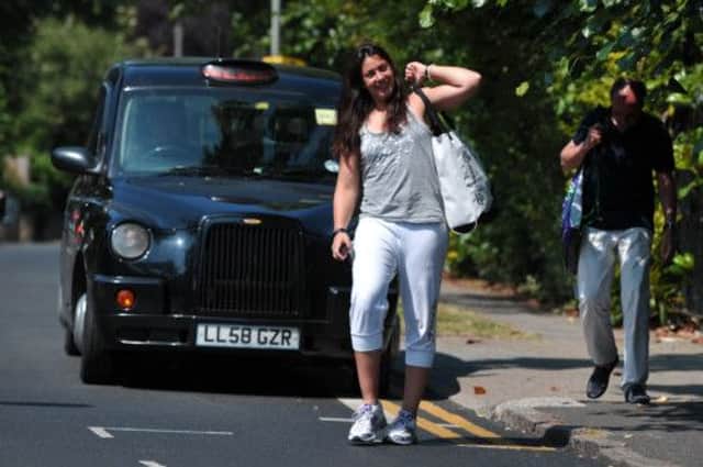 Marion Bartoli arrives in a taxi with her father Walter for her champions press conference at Wimbledon yesterday. Picture: Getty