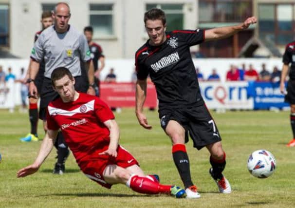 Rangers forward Andrew Little is tackled by Broras Gavin Morrison at Dudgeon Park yesterday. Picture: SNS