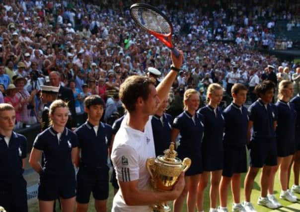 Victorious Andy Murray turns to give another wave to the Centre Court crowd. Picture: Getty